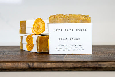 Sweet orange organic tallow soap bar with stacked bars and yellow wax seals.