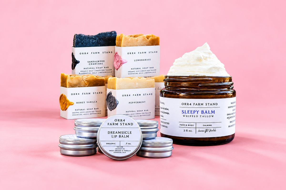 Orr4 Farm Stand tallow skincare, soaps and lip balms on a pink background.